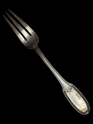 a silver fork with a silver handle on a black background