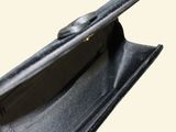 a black purse with a zipper on the inside of it