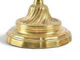 a gold candle holder with a candle on top of it