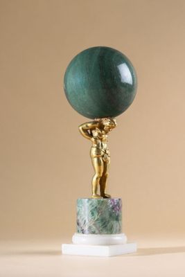statue of a woman holding a green marble ball on a marble base