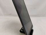 a close up of a tablet computer on a stand on a white surface