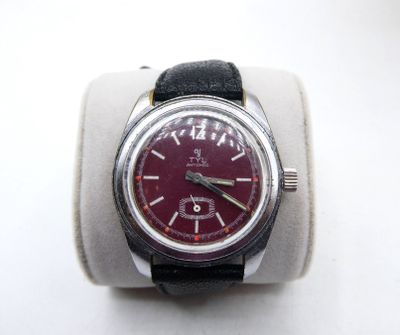 a watch that is sitting on top of a watch stand