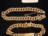a close up of a gold chain with a tag on it