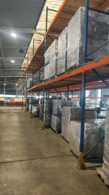 de nombreuses palettes de cartons sur les rayonnages de l'entrepôt