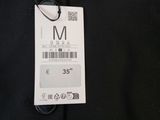 a close up of a black shirt with a tag on it