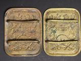 two antique brass trays with the names of flowers and leaves