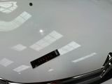 a close up of a car ' s hood with a sticker on it