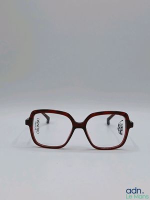 a pair of glasses sitting on top of a white surface