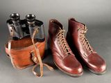two pairs of boots and a pair of binoculars on a gray background