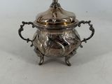 an antique silverplated sugar dish with a lid and handles