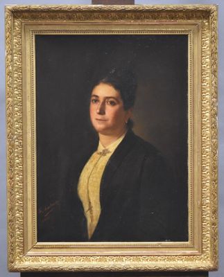 portrait of a woman in a black jacket and yellow shirt