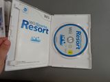someone is holding a wii game in a white case