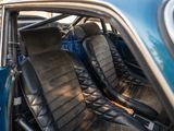 two black leather seats in the back of a blue car