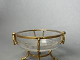 an image of a glass bowl with gold handles on a stand