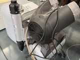 a blow dryer sitting on the floor next to a microwave