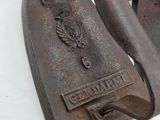 a pair of old iron ironing tools on a white surface
