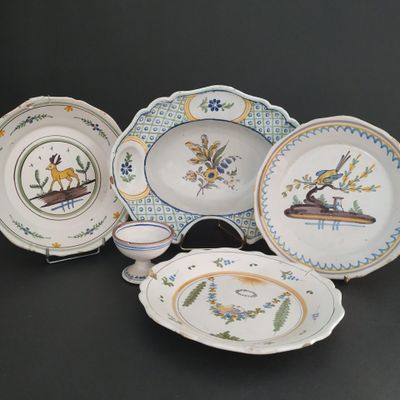 five plates and a bowl on a black table