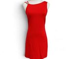 the red dress is on a mannequin stand against a white wall