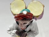 a figurine of a mouse with a hat on
