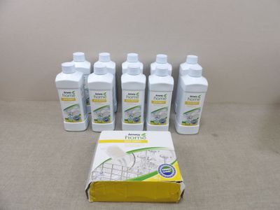 four bottles of liquid sitting on top of a table next to a box