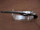 a gun that is sitting on top of a clear box