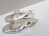 pair of women ' s silver shoes on a white surface