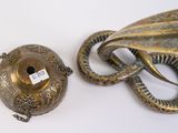 a snake that is sitting next to a metal object