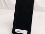 the back of a black cell phone sitting on top of a table