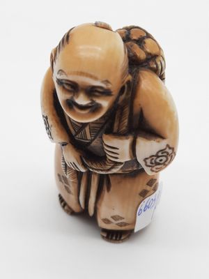 a small figurine of a man with a bag on his back