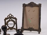three picture frames and a candle holder on the table