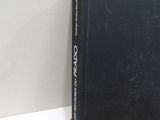 a black book sitting on top of a wicker basket