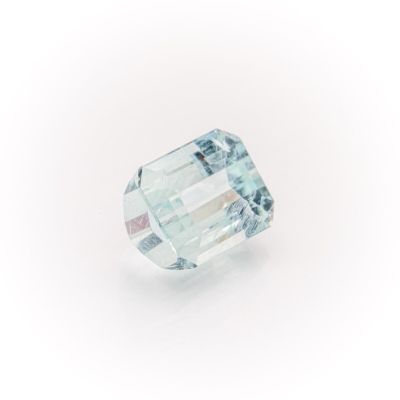 a close up of a green and white diamond on a white surface