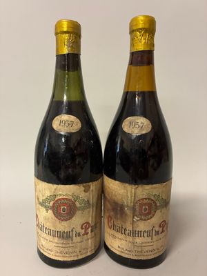 two bottles of wine sitting next to each other on a table