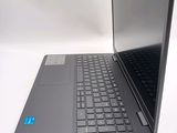 a laptop computer sitting on a table with a blue sticker on the keyboard