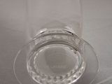 a clear glass cup with a saucer on top of it