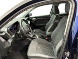 the interior of a blue car with a steering wheel and dashboard
