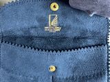 a close up of a blue sued purse with a zipper