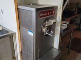 a machine that is sitting in a kitchen next to a sink