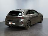 the rear end of a grey car parked in a room