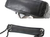 a black purse with a chain around it and a black purse with a chain around it