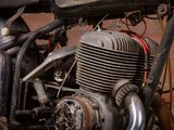 a close up of a motorcycle engine with a brick wall in the background