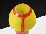a vase with a yellow and red design on it