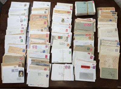 several stacks of mail sitting on top of a wooden table
