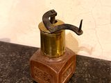 a small metal and wood grinder on a counter