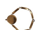 an image of a gold bracelet with a coin on it