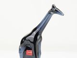 a black giraffe figurine with a red tag on it ' s neck