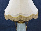 a lamp that has a white shade on it