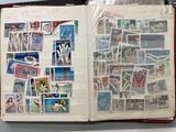 an open book with stamps on it on a table