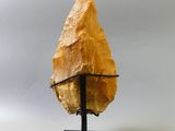 a large yellow stone arrow on a black stand