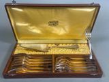 a wooden box with a set of silverware in it